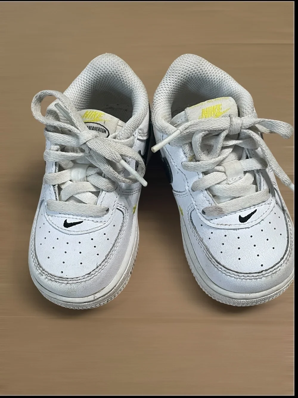 Nike Toddler White Sneakers with Black Swoosh and Yellow Star